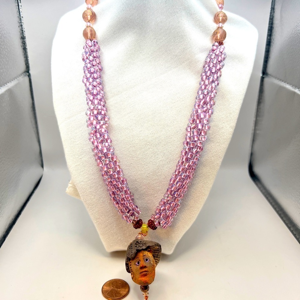 Unique clay head pendant on a glass beaded and faux seed pearl necklace